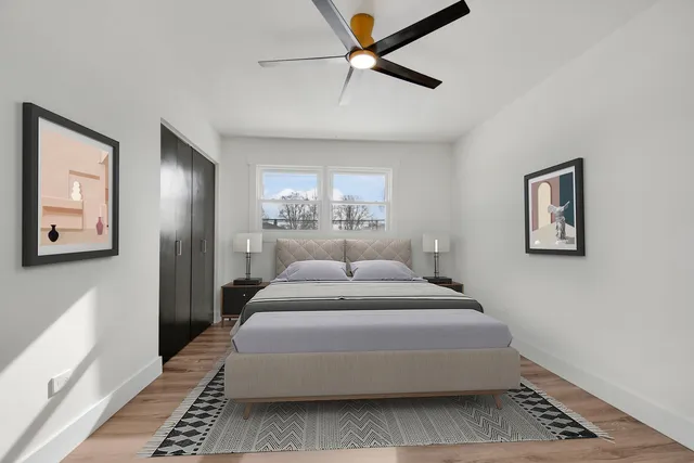 a spacious bedroom with a bed and a chandelier