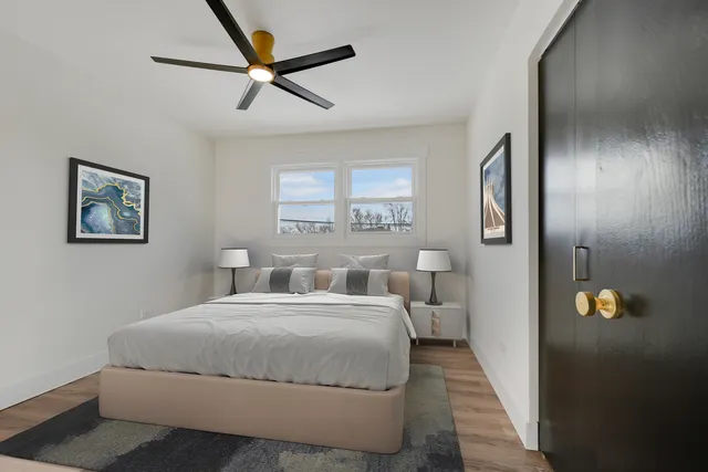 a bedroom with a large bed and a chandelier