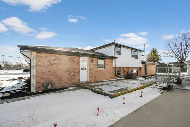 a view of a house with a snow in the background