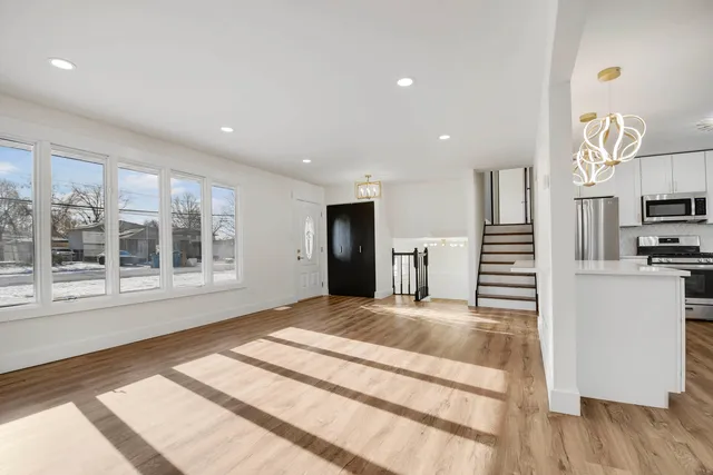 a large bedroom with a bed and a large window