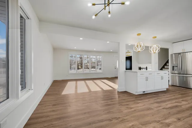 a view of kitchen with microwave and wooden floor