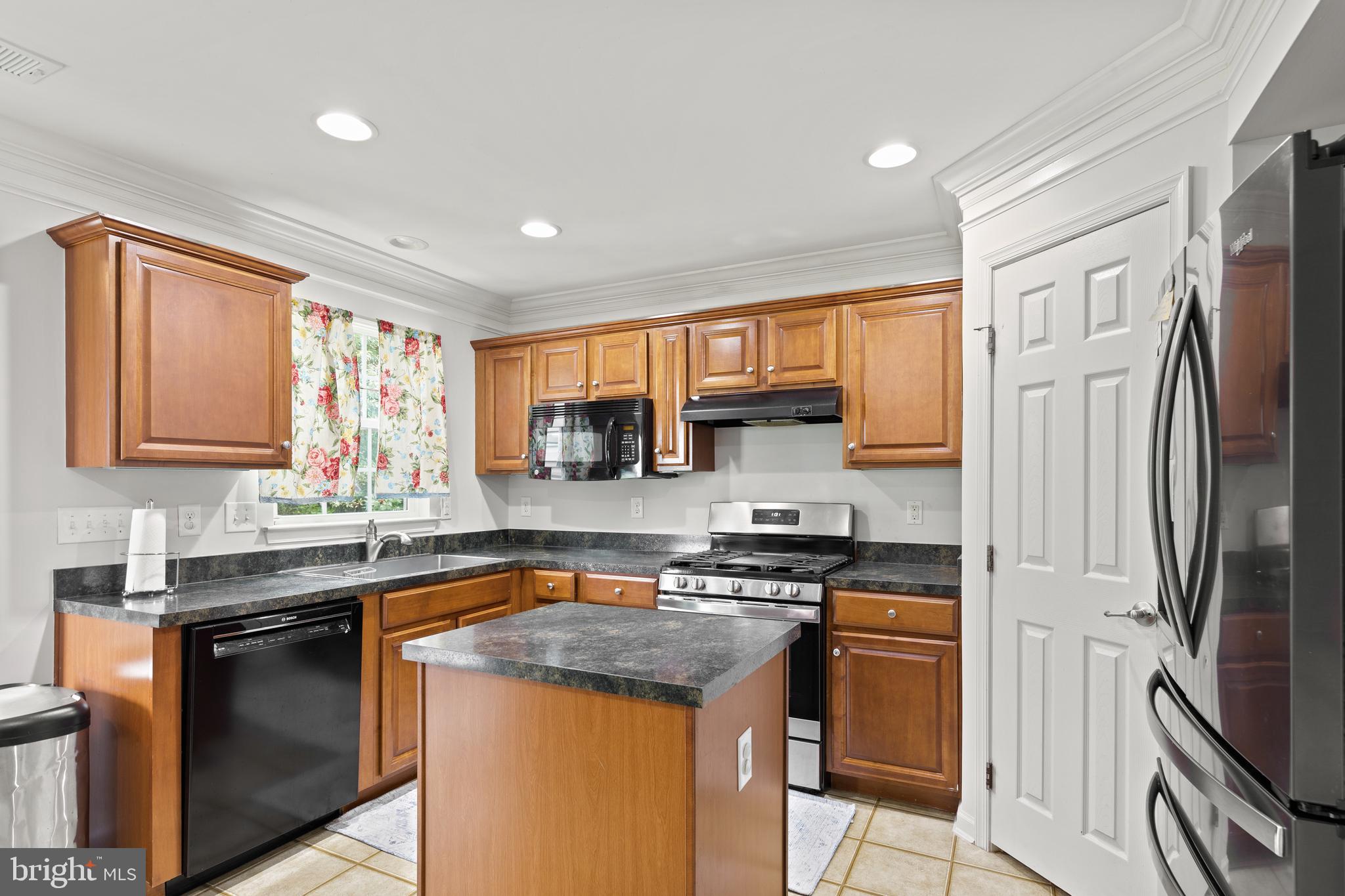 196 Bobbys Branch Road Millsboro, DE 19966 - Photo 12 of 37 a kitchen with stainless steel appliances granite countertop a sink stove refrigerator and cabinets