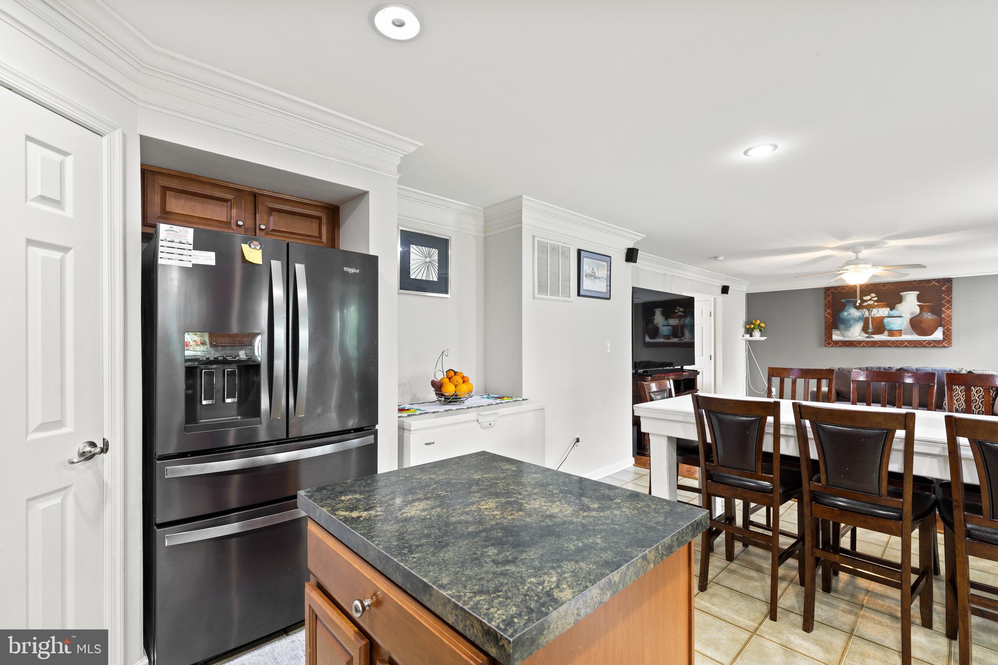196 Bobbys Branch Road Millsboro, DE 19966 - Photo 16 of 37 a kitchen with stainless steel appliances granite countertop a refrigerator and dining table