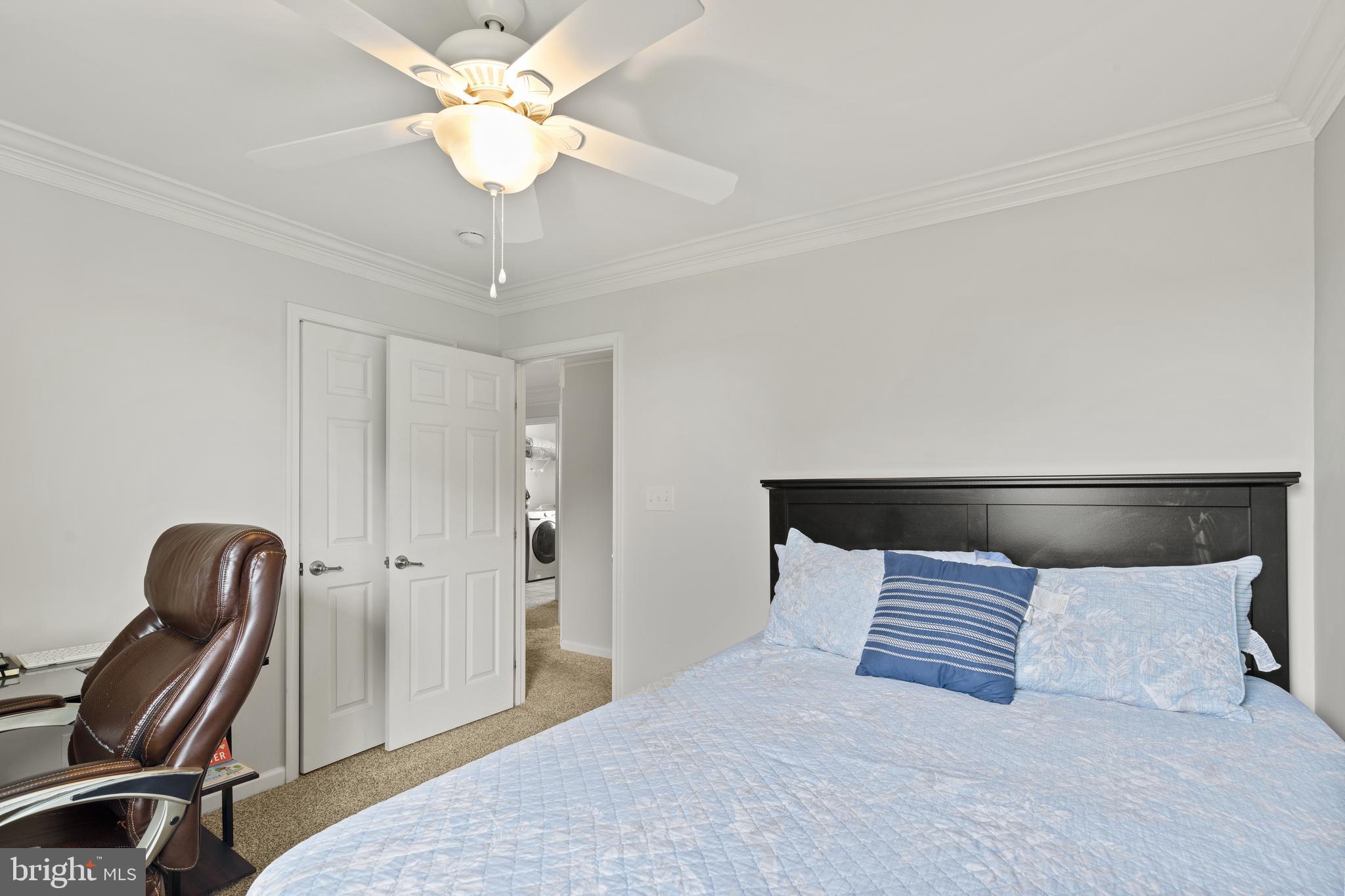 196 Bobbys Branch Road Millsboro, DE 19966 - Photo 22 of 37 a bedroom with a bed and a chandelier