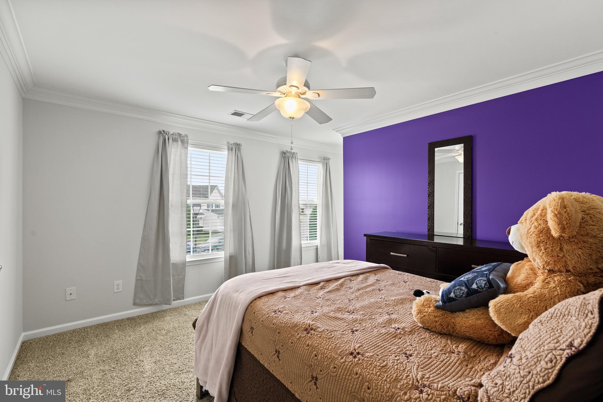 196 Bobbys Branch Road Millsboro, DE 19966 - Photo 24 of 37 a bedroom with a bed and a chandelier