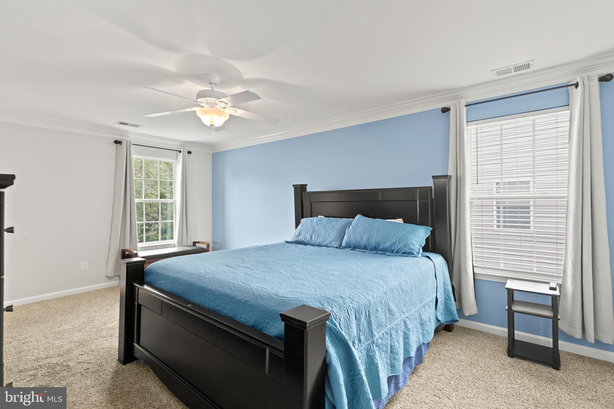 196 Bobbys Branch Road Millsboro, DE 19966 - Photo 27 of 37 a bedroom with a bed and a chandelier