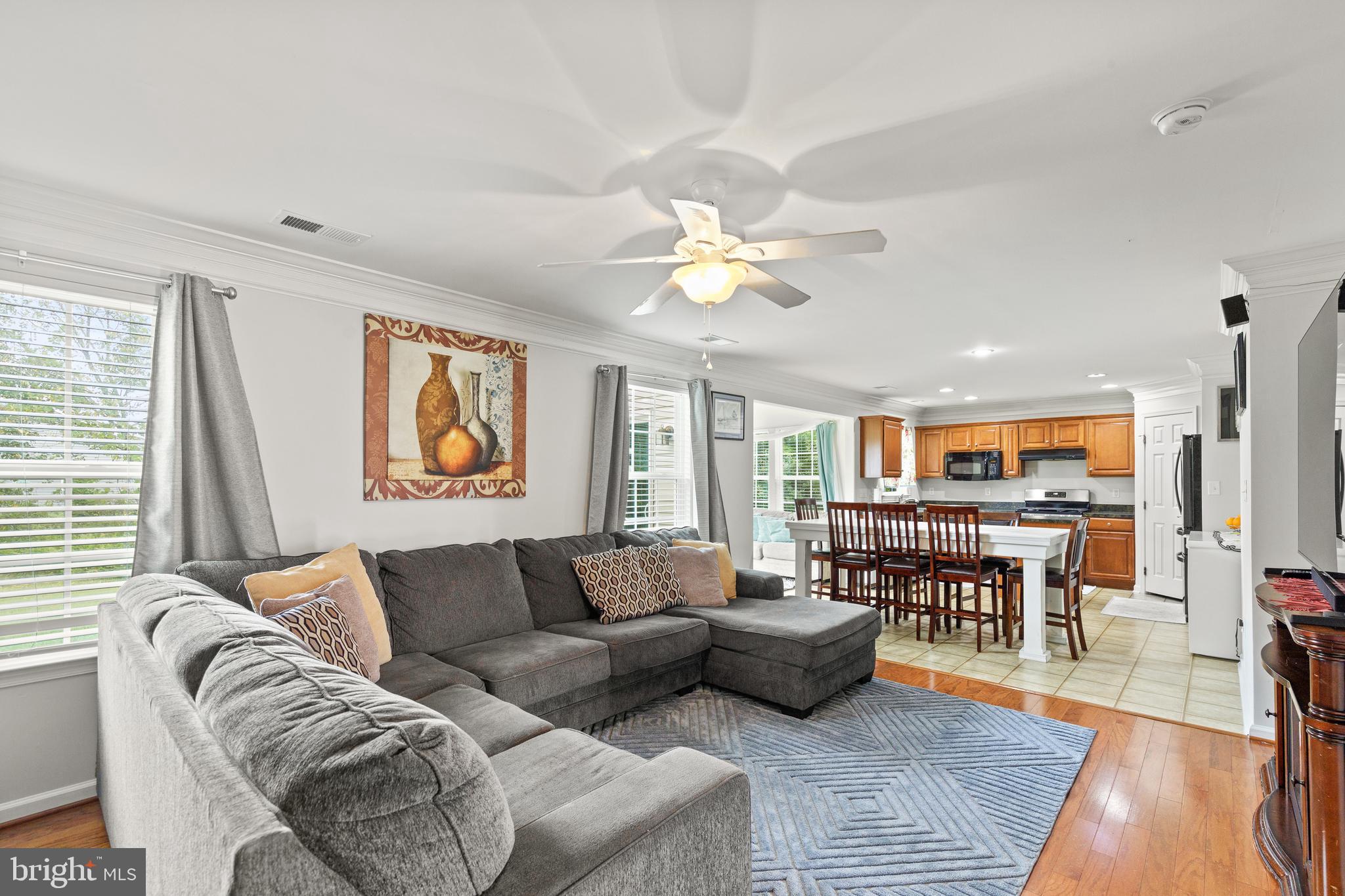 196 Bobbys Branch Road Millsboro, DE 19966 - Photo 5 of 37 a living room with furniture kitchen view and a wooden floor