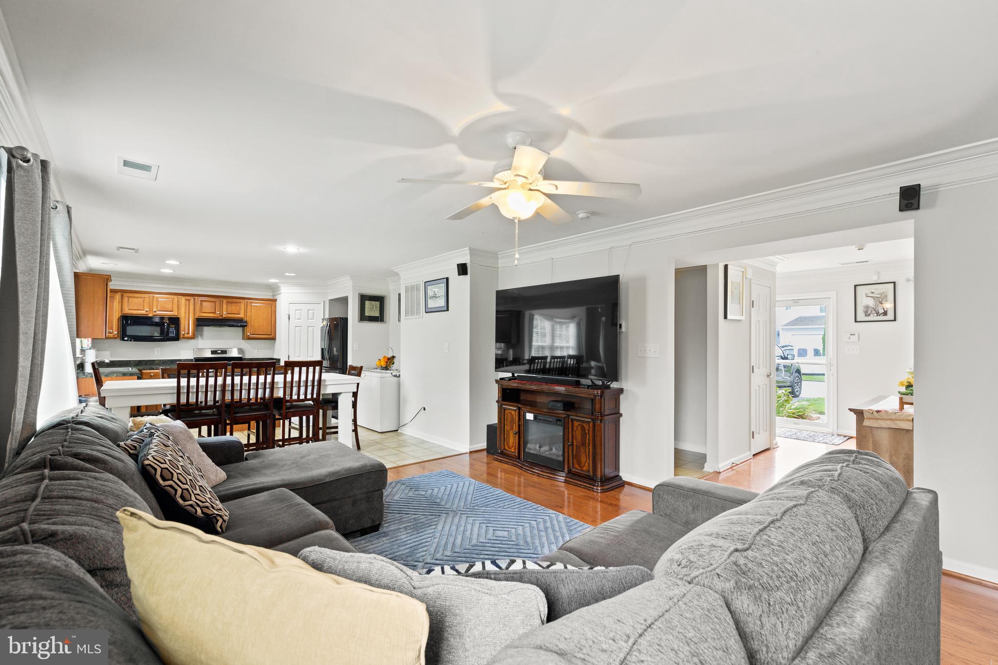 196 Bobbys Branch Road Millsboro, DE 19966 - Photo 6 of 37 a living room with furniture and a flat screen tv with wooden floor