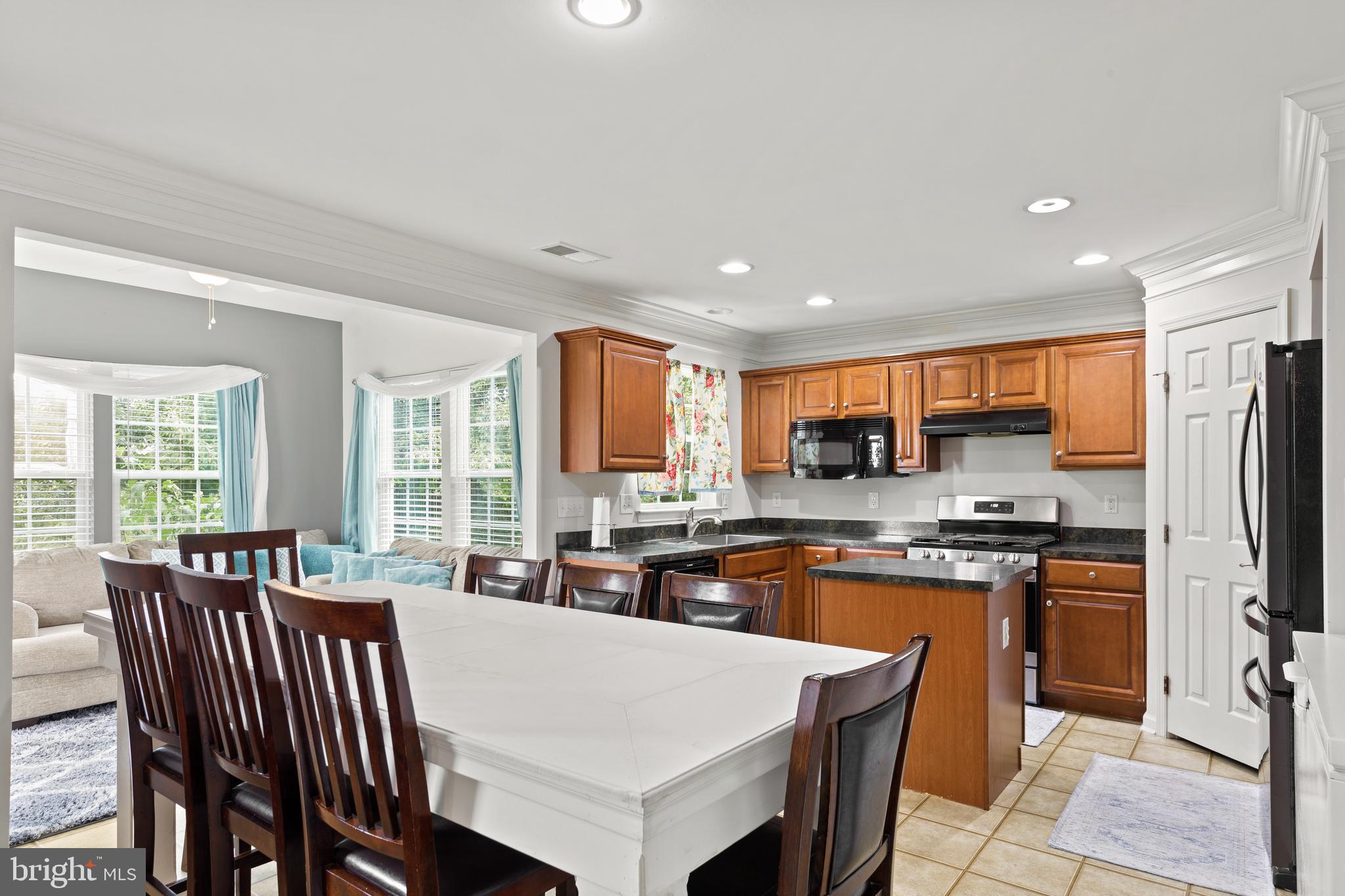 196 Bobbys Branch Road Millsboro, DE 19966 - Photo 10 of 37 a large kitchen with kitchen island a sink table and chairs