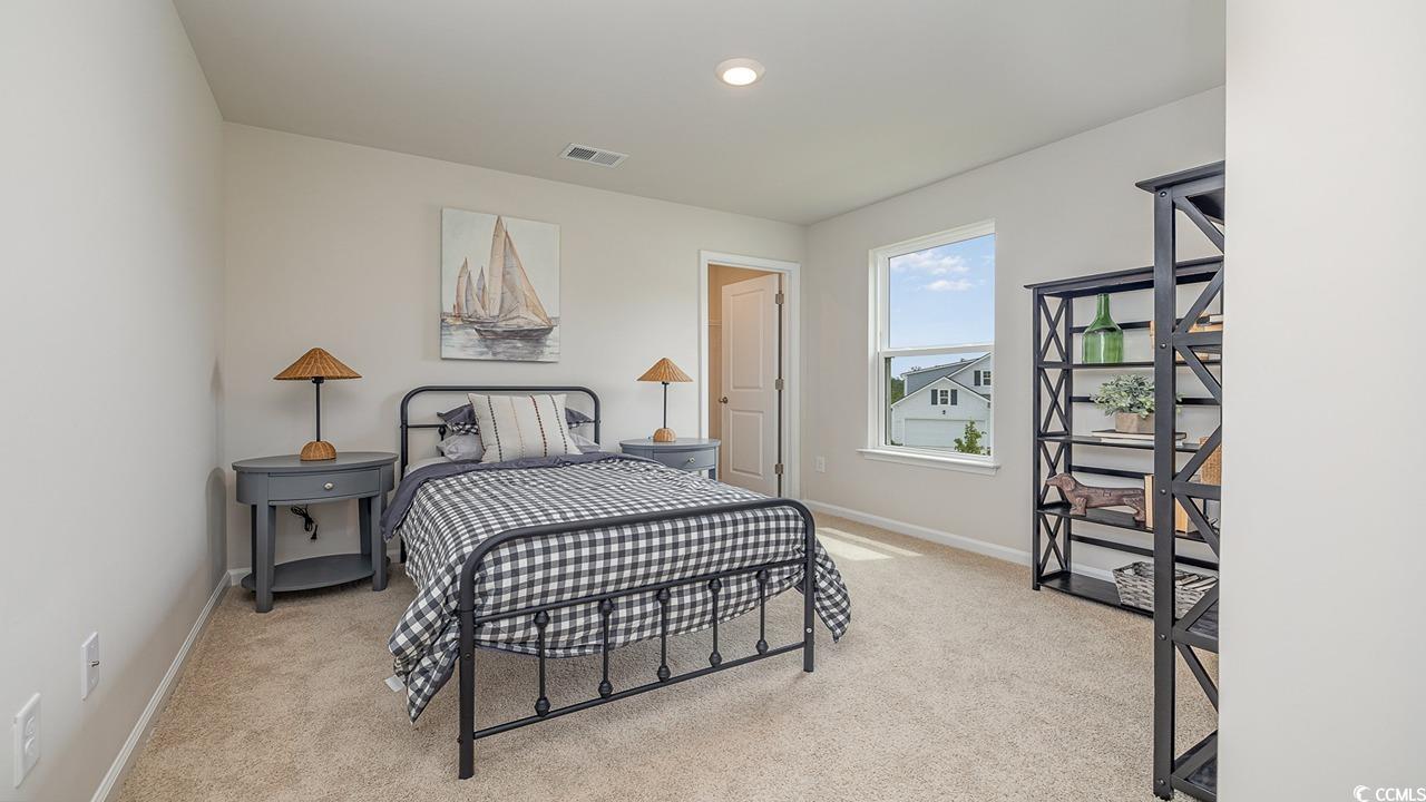 303 Ridley Street Longs, SC 29568 - Photo 26 of 31 Bedroom with light colored carpet