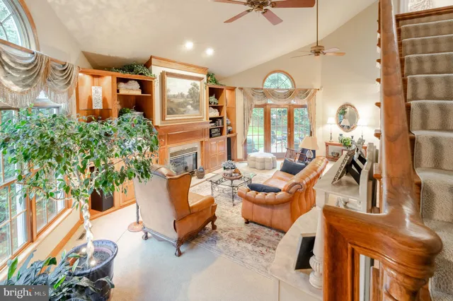 a living room with patio furniture and a chandelier