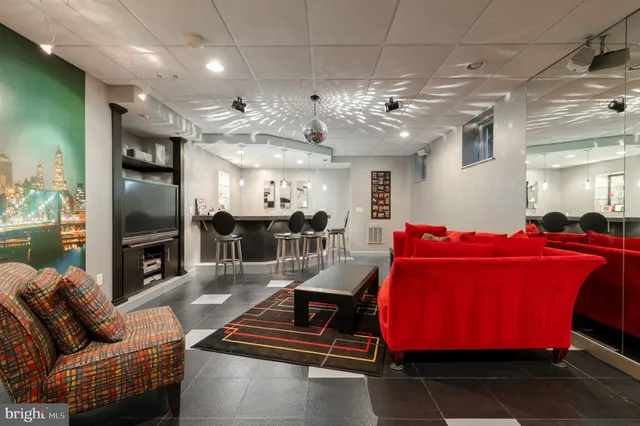 a living room with furniture gym equipment and a fireplace