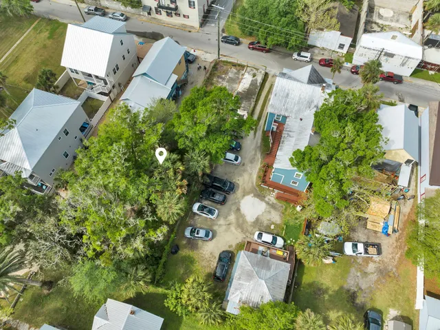 an aerial view of residential house with outdoor space and trees all around