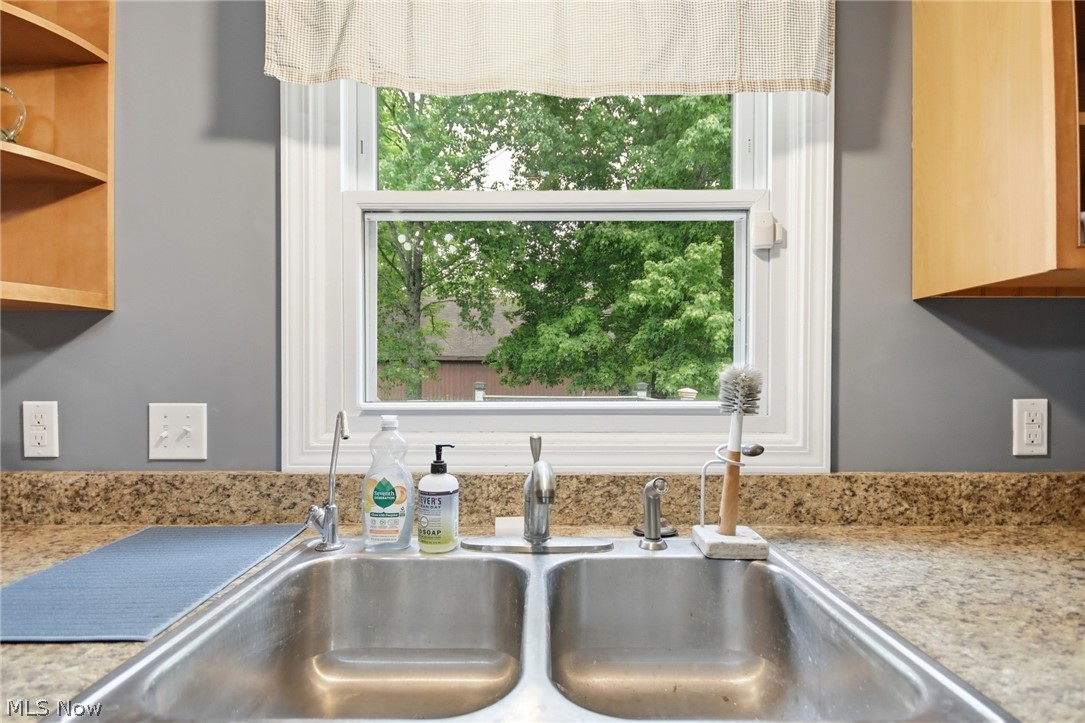 2591 Wayland Road Deerfield, OH 44411 - Photo 12 of 46 Kitchen sink featuring a dual basin, stainless steel faucet, and a window with white trim