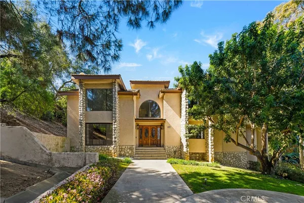 a front view of a house with garden
