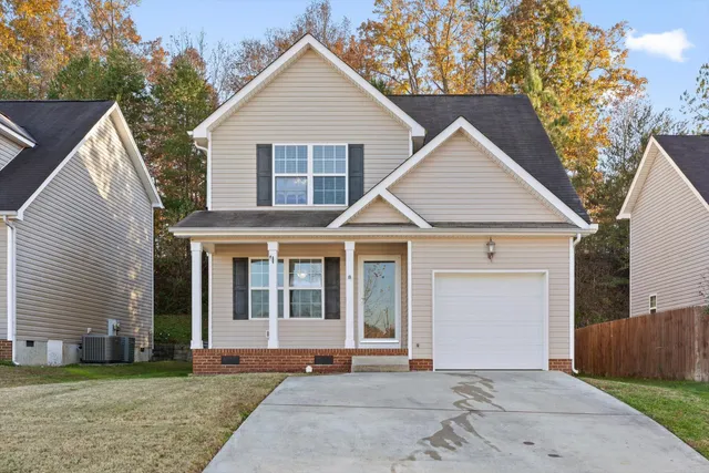 a view of a house with a yard and garage