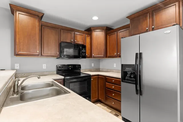 a kitchen with a sink appliances and cabinets