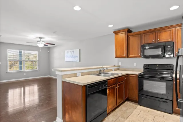 a kitchen with a stove sink and microwave