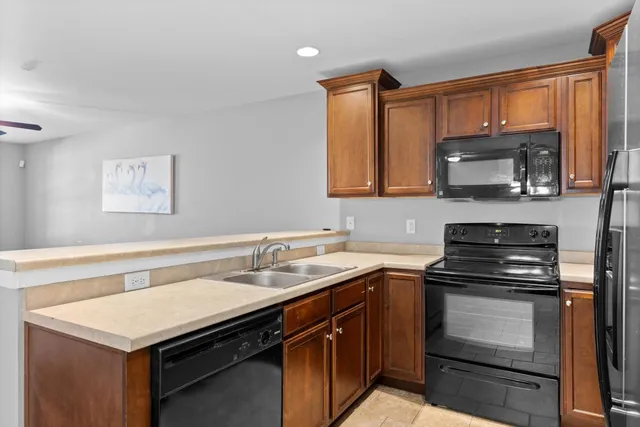 a kitchen with a sink stove and microwave
