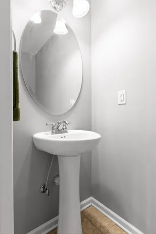 a bathroom with a sink a mirror and toilet