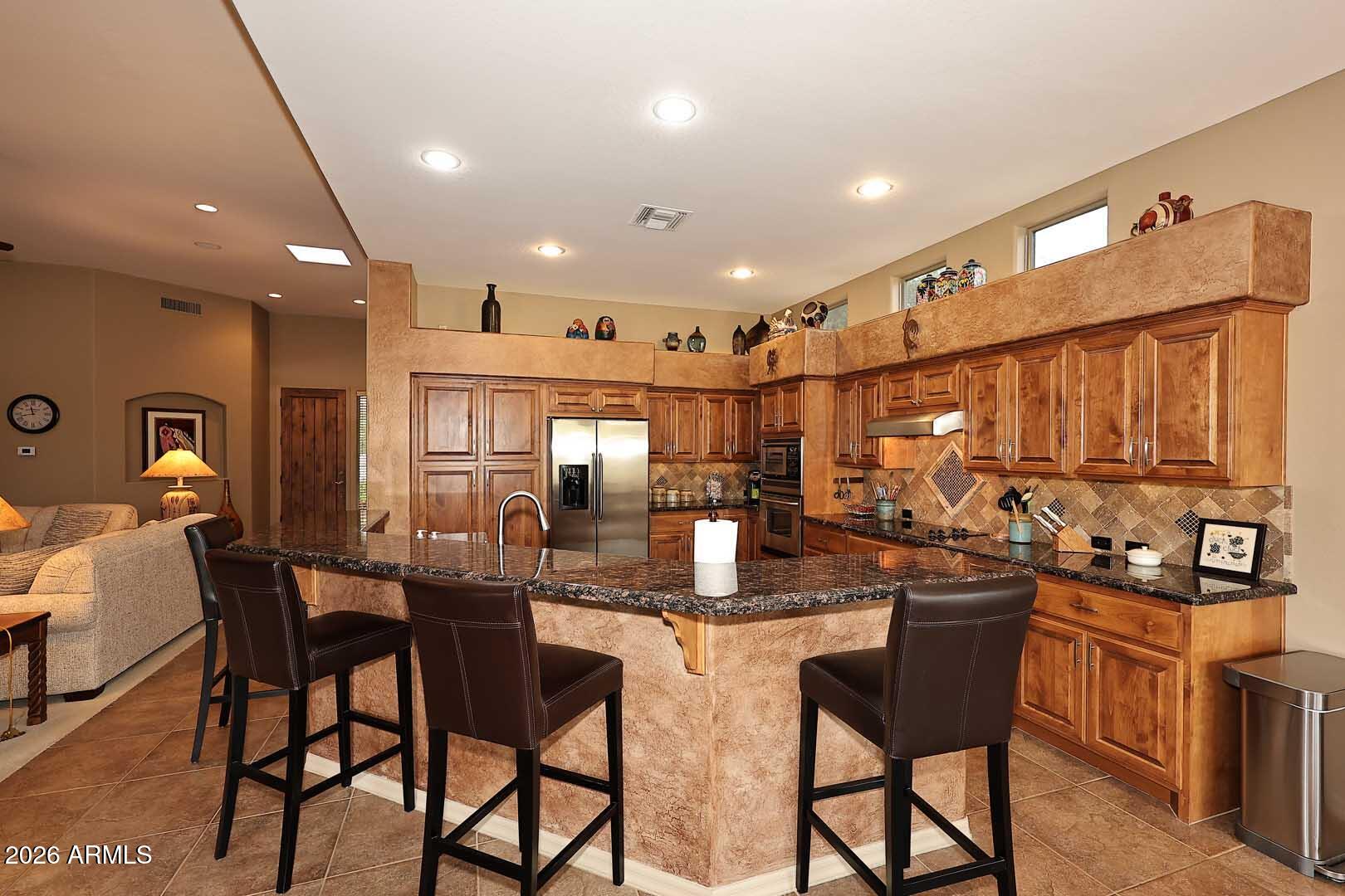 27921 North Quail Spring Road Rio Verde, AZ 85263 - Photo 12 of 49 a kitchen with a table and chairs