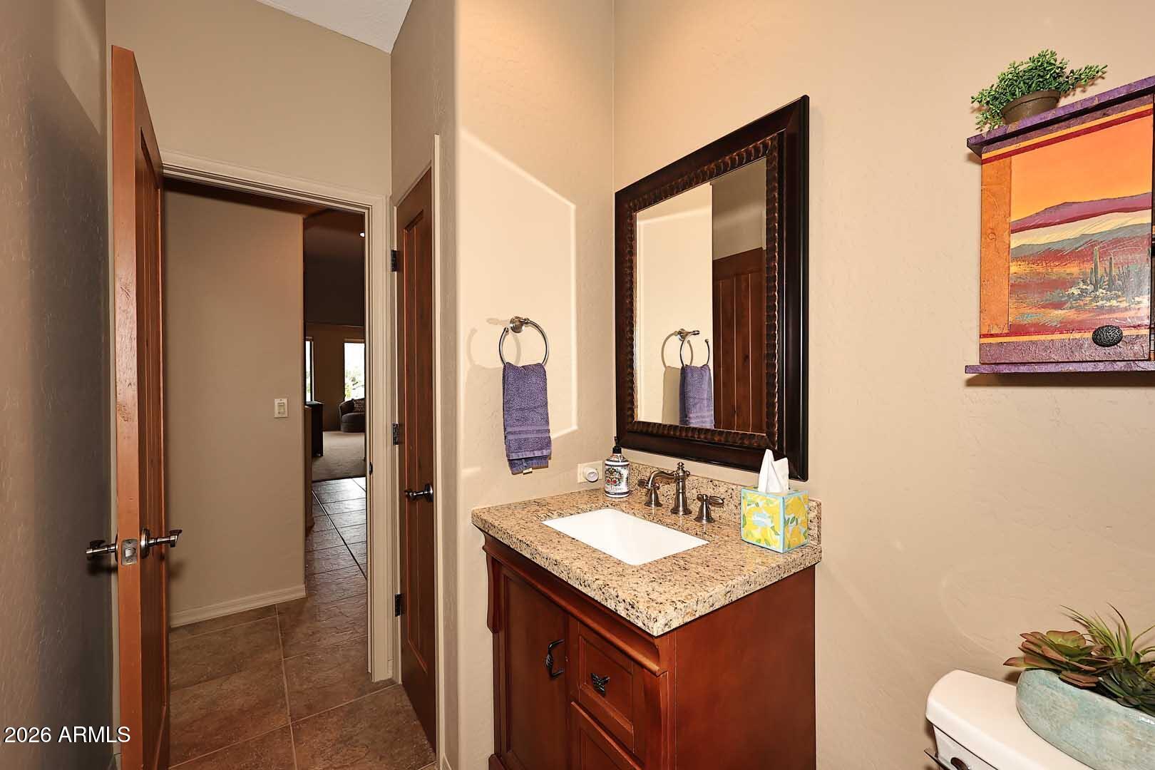 27921 North Quail Spring Road Rio Verde, AZ 85263 - Photo 15 of 49 a bathroom with a sink vanity mirror and toilet