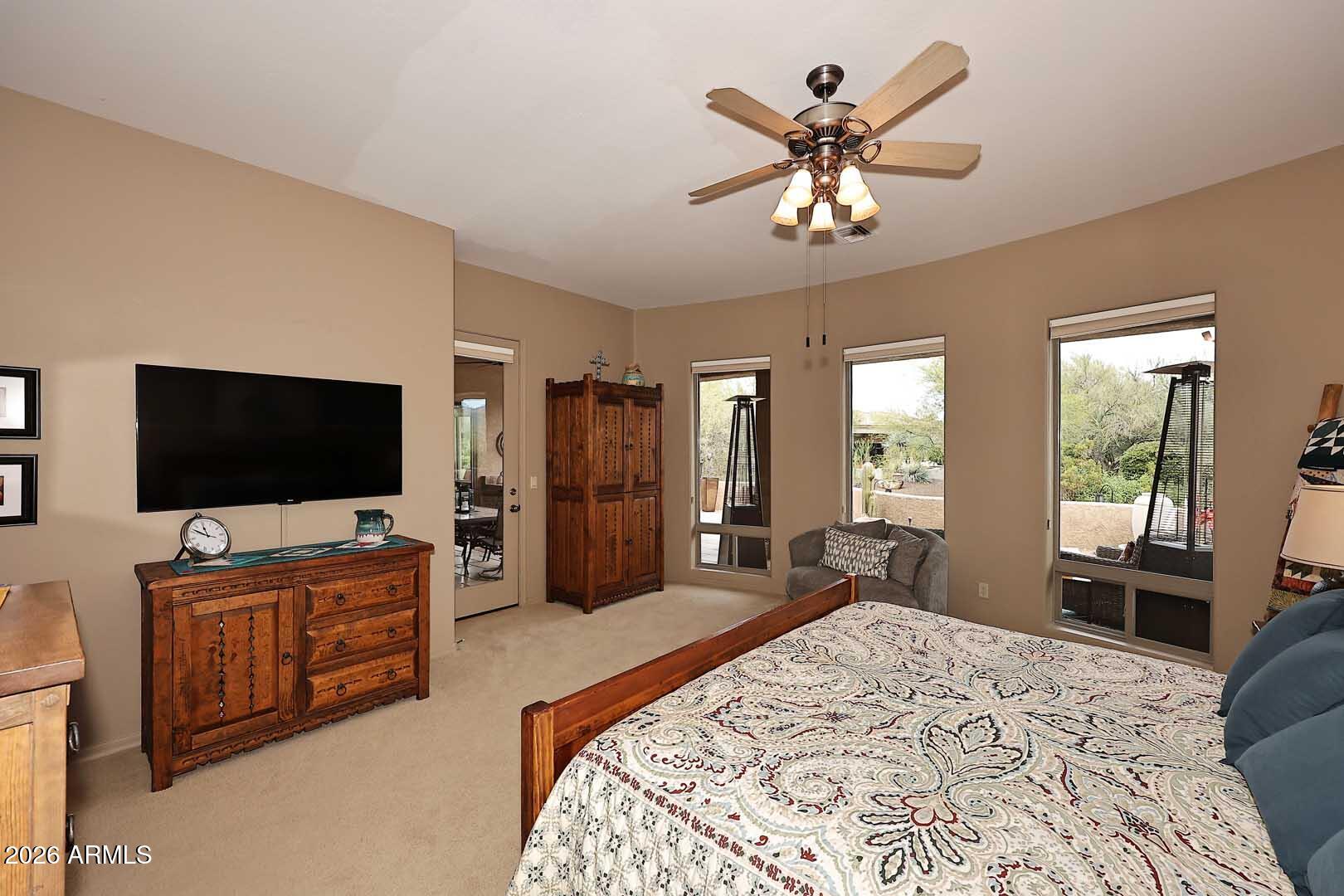 27921 North Quail Spring Road Rio Verde, AZ 85263 - Photo 21 of 49 a bedroom with furniture and a flat screen tv