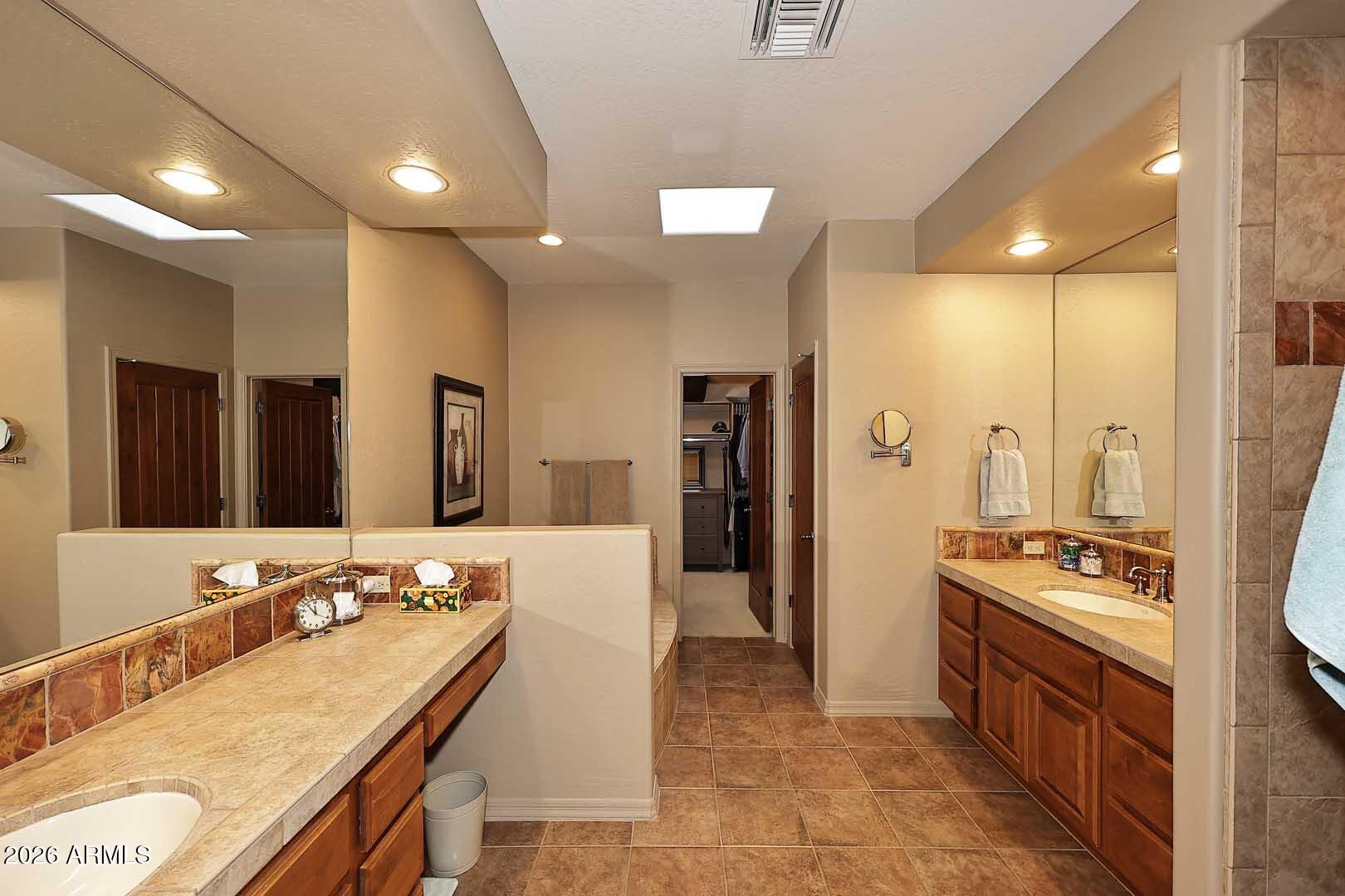 27921 North Quail Spring Road Rio Verde, AZ 85263 - Photo 22 of 49 a large bathroom with a large mirror vanity and shower