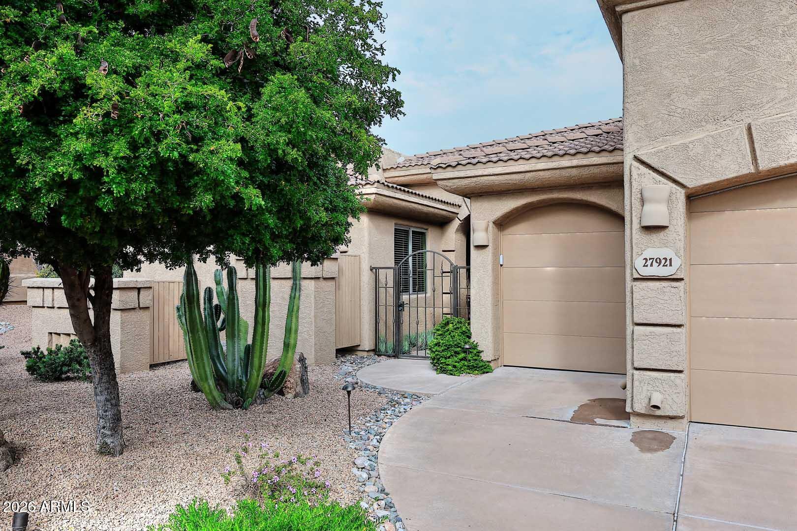 27921 North Quail Spring Road Rio Verde, AZ 85263 - Photo 3 of 49 a front view of a house with garden