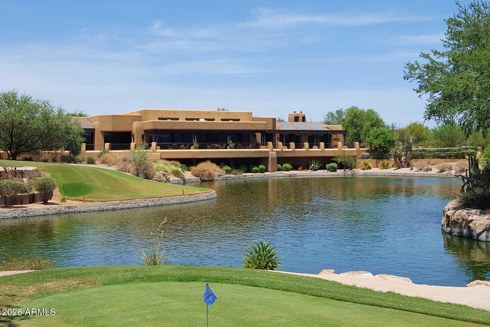 27921 North Quail Spring Road Rio Verde, AZ 85263 - Photo 42 of 49 a view of a lake with a house in the background