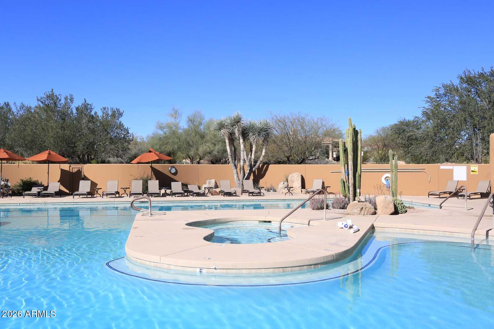 27921 North Quail Spring Road Rio Verde, AZ 85263 - Photo 46 of 49 a view of a swimming pool with lounge chairs