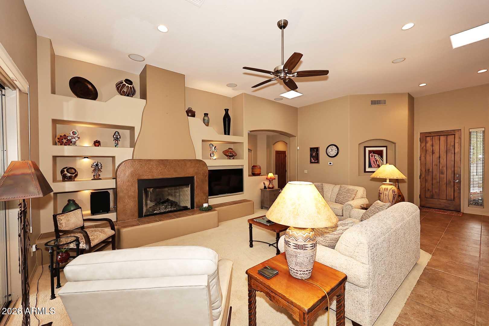 27921 North Quail Spring Road Rio Verde, AZ 85263 - Photo 6 of 49 a living room with furniture and a fireplace