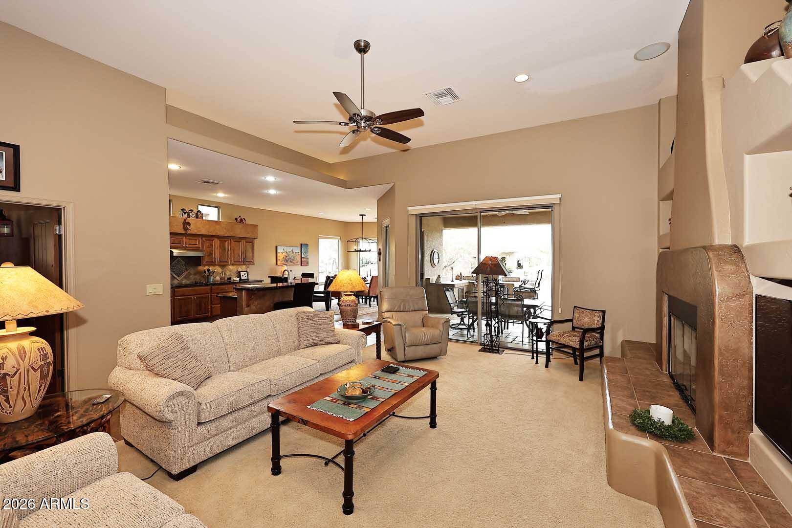 27921 North Quail Spring Road Rio Verde, AZ 85263 - Photo 8 of 49 a living room with furniture and a fireplace