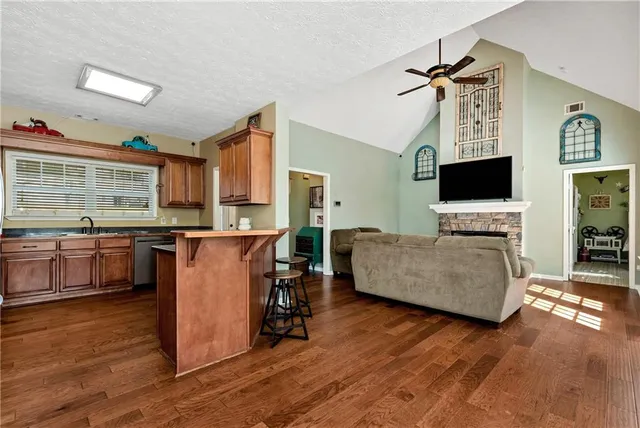 a living room with furniture a flat screen tv and a fireplace