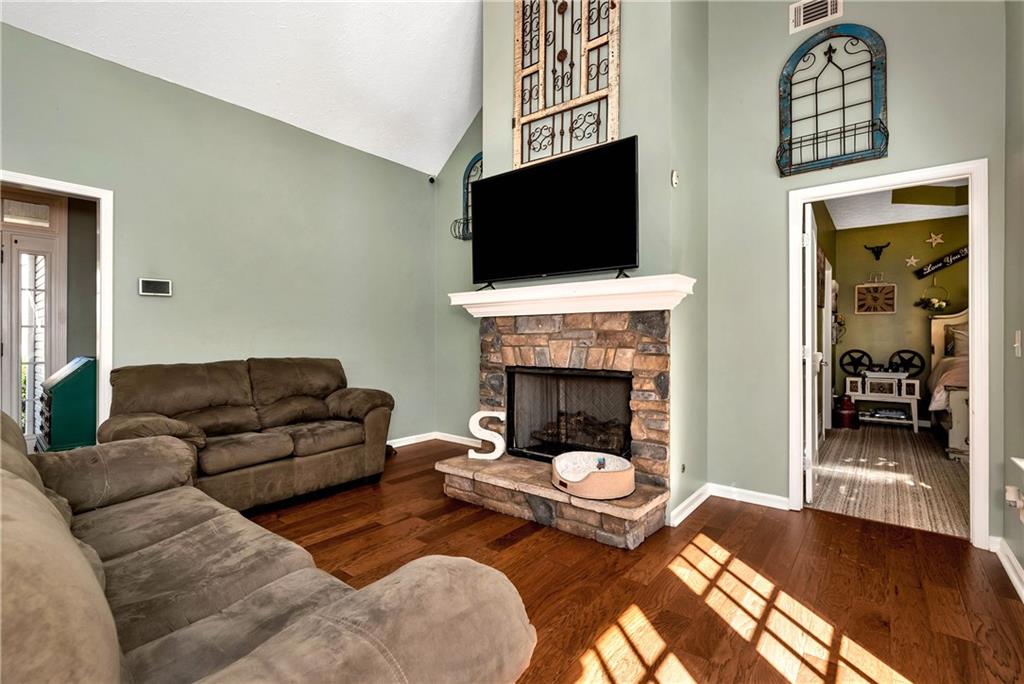 750 Rock Springs Road Lula, GA 30554 - Photo 15 of 72 a living room with furniture a flat screen tv and a fireplace