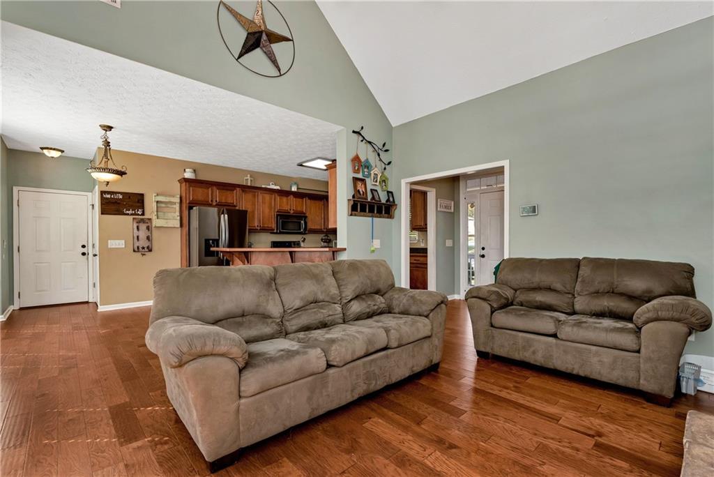 750 Rock Springs Road Lula, GA 30554 - Photo 16 of 72 a living room with furniture and a black refrigerator