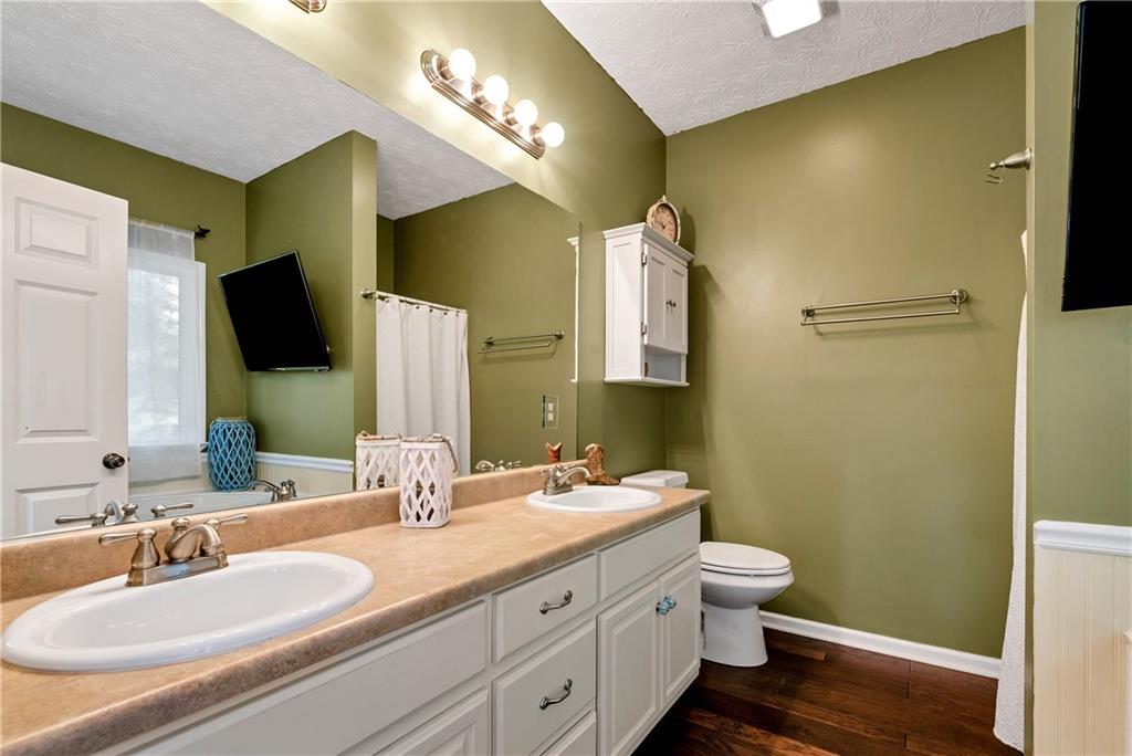 750 Rock Springs Road Lula, GA 30554 - Photo 21 of 72 a bathroom with a double vanity sink a mirror and a toilet