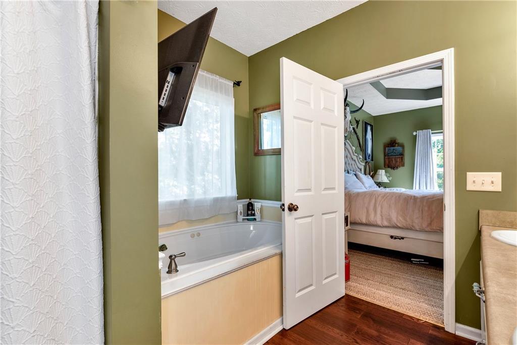 750 Rock Springs Road Lula, GA 30554 - Photo 22 of 72 a en suite bathroom with a tub sink and mirror