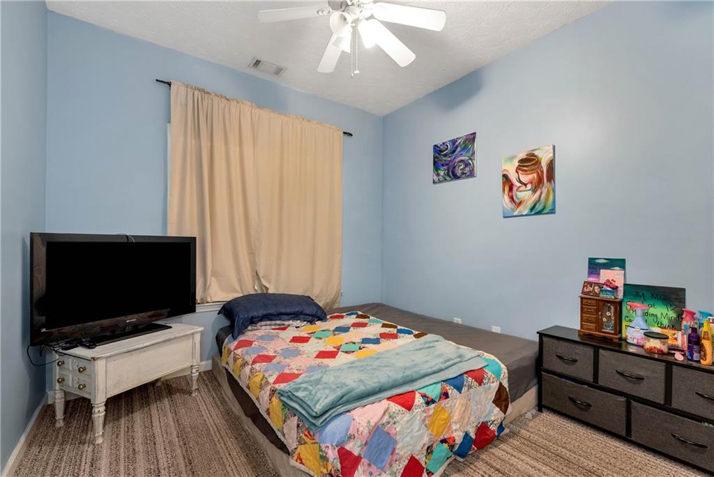 750 Rock Springs Road Lula, GA 30554 - Photo 34 of 72 a bedroom with a bed and a flat screen tv