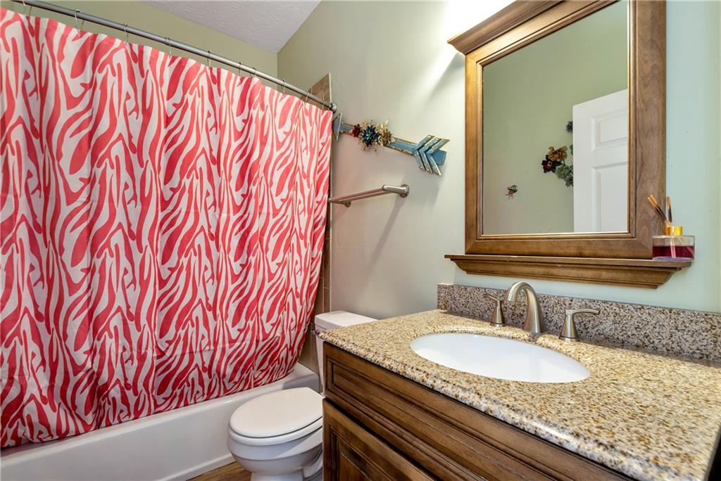 750 Rock Springs Road Lula, GA 30554 - Photo 36 of 72 a bathroom with a granite countertop sink and a mirror
