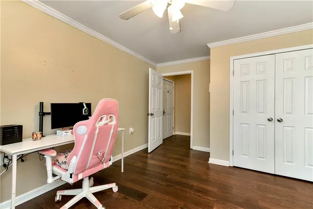 a front view of a house with a garden and trees