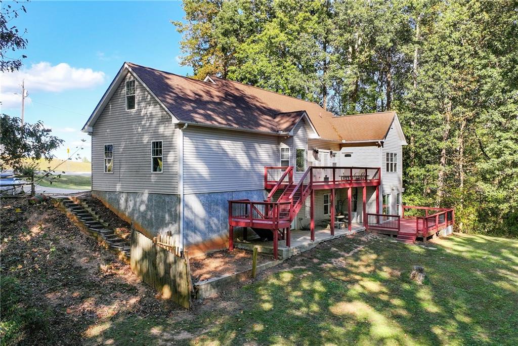 750 Rock Springs Road Lula, GA 30554 - Photo 64 of 72 a view of a house with a yard patio and fire pit