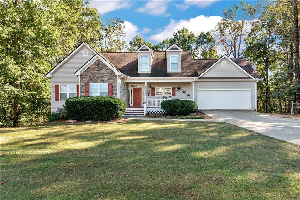 750 Rock Springs Road Lula, GA 30554 - Photo 66 of 72 a front view of a house with a garden and trees