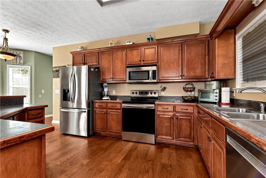750 Rock Springs Road Lula, GA 30554 - Photo 8 of 72 a kitchen with a refrigerator stove and microwave