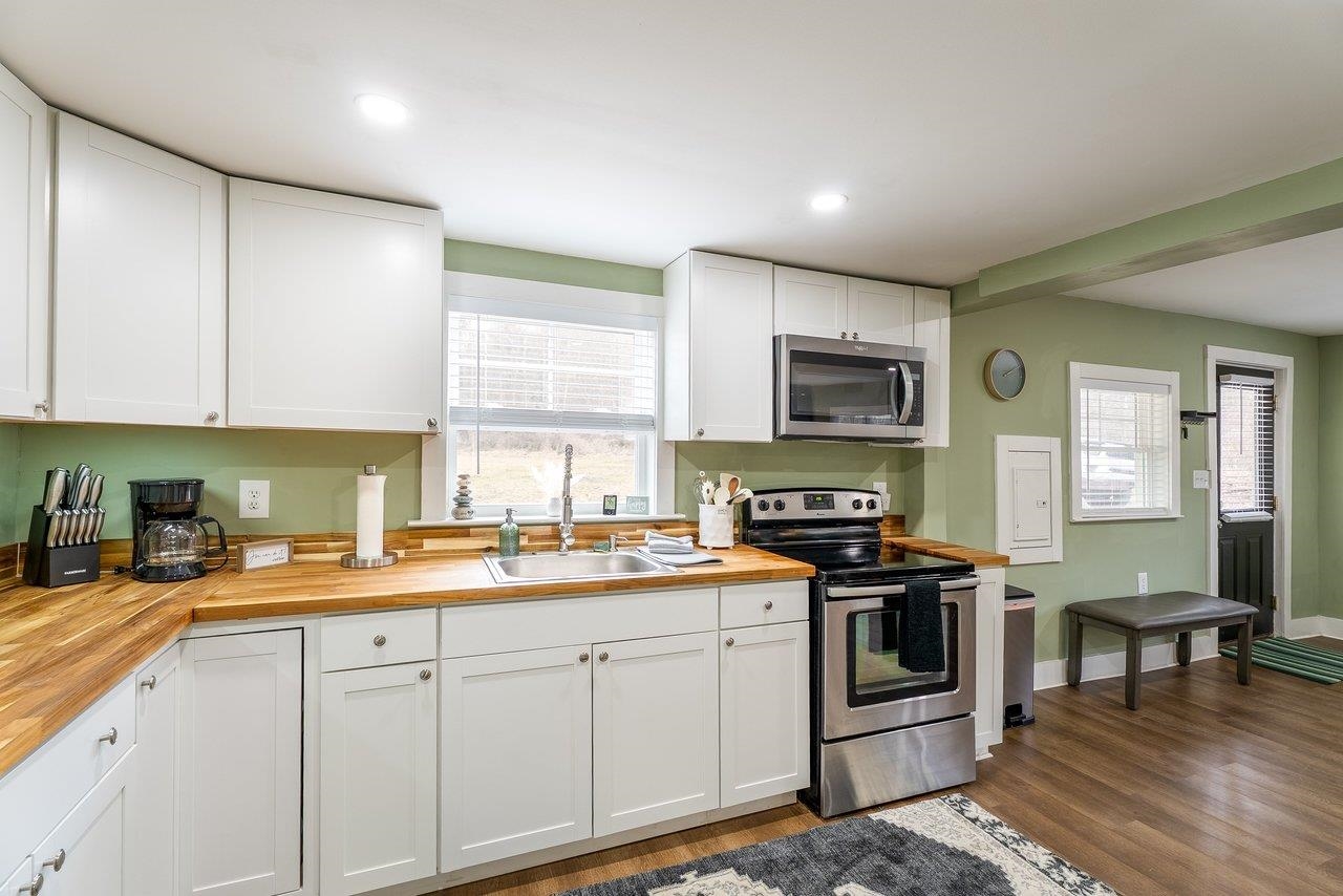 29 Shenandoah Mountain Road Sugar Grove, WV 26815 - Photo 16 of 52 a kitchen with stainless steel appliances granite countertop a stove a sink dishwasher and a microwave oven with white cabinets