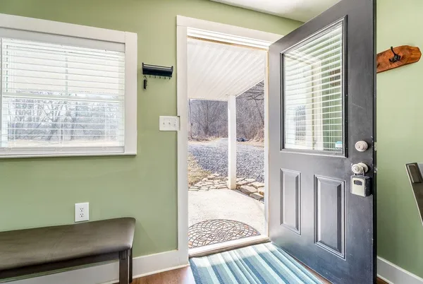 a view of a room that has a bed and a window in it