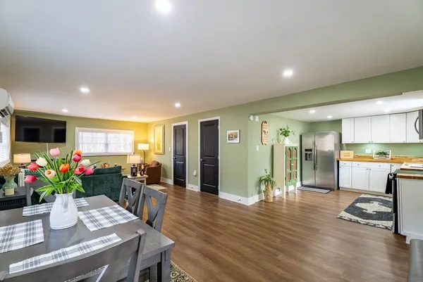a dining room with furniture and wooden floor