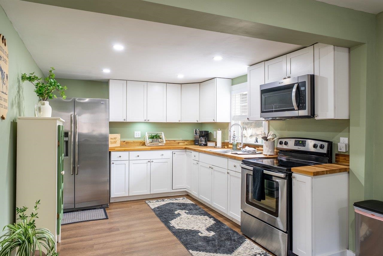 29 Shenandoah Mountain Road Sugar Grove, WV 26815 - Photo 9 of 52 a kitchen with stainless steel appliances granite countertop a stove a refrigerator and a microwave