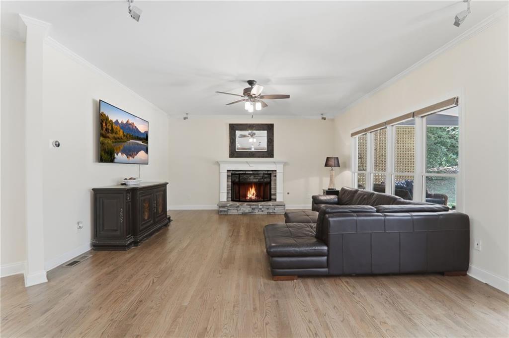 67 Pointer Lane Braselton, GA 30517 - Photo 20 of 74 a living room with furniture a fireplace and a flat screen tv