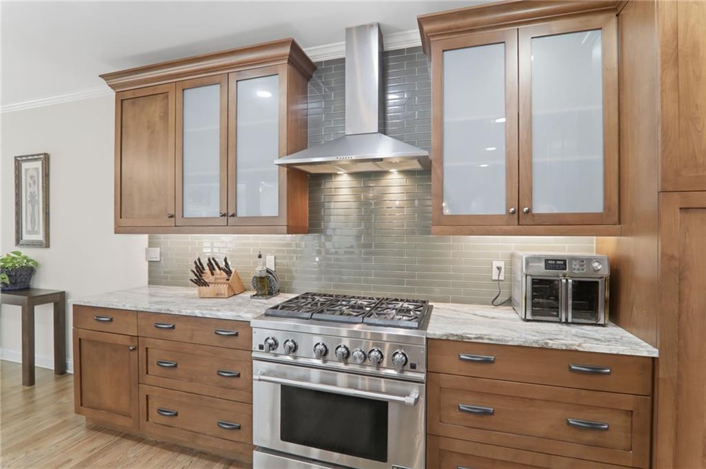 67 Pointer Lane Braselton, GA 30517 - Photo 24 of 74 a kitchen with stainless steel appliances granite countertop a stove and a sink